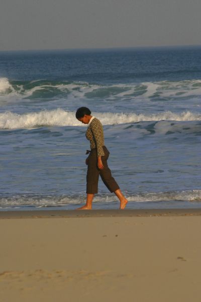 Woman in deep thoughts on beach